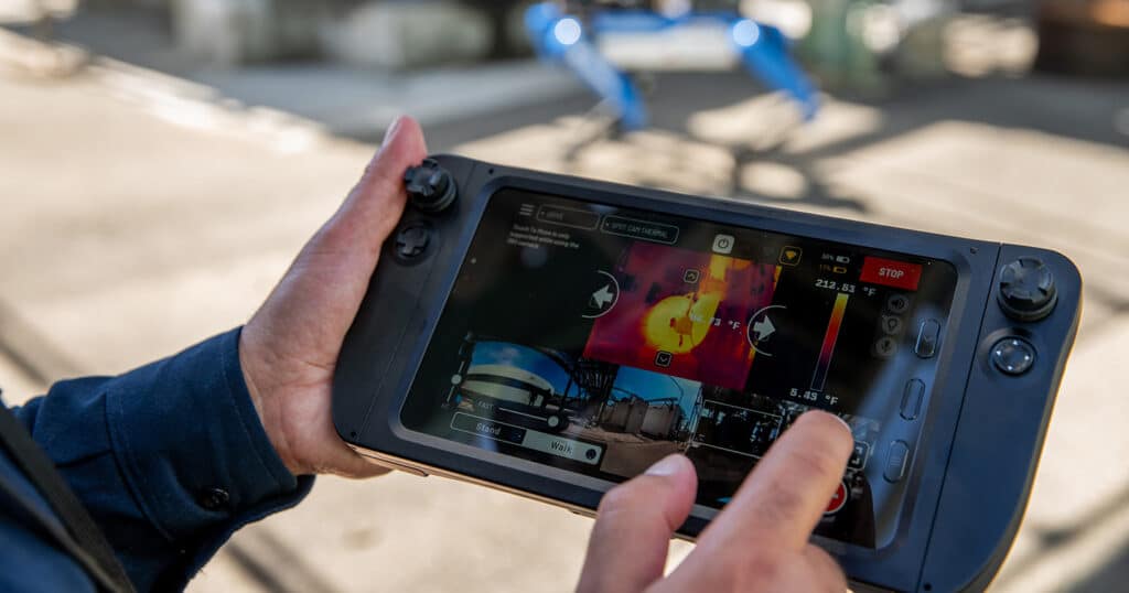 An operator records a thermal reading of a motor using the Spot tablet