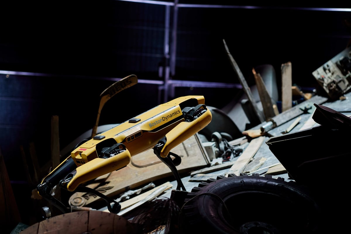 Spot climbs a staged rubble pile.