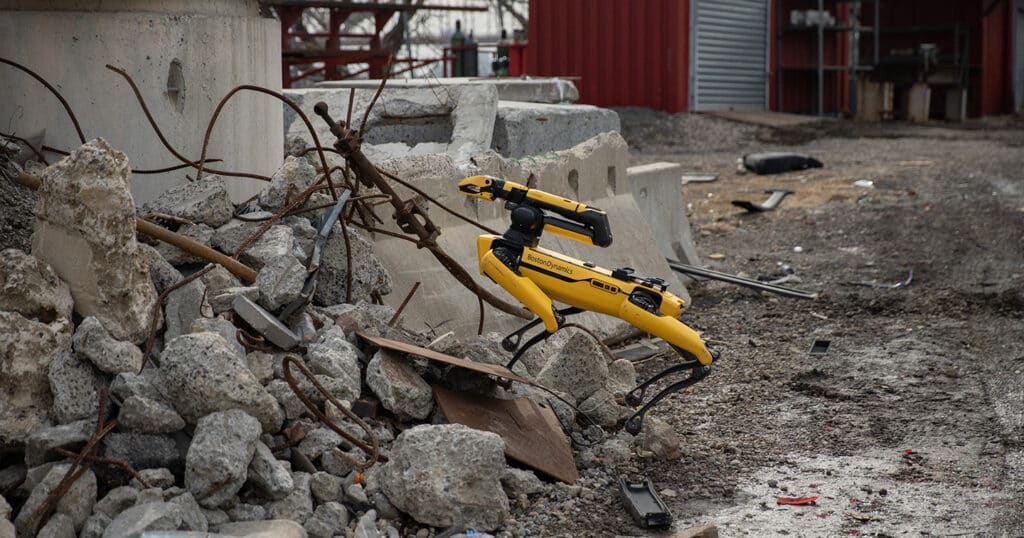 Spot climbs over rubble on a disaster site