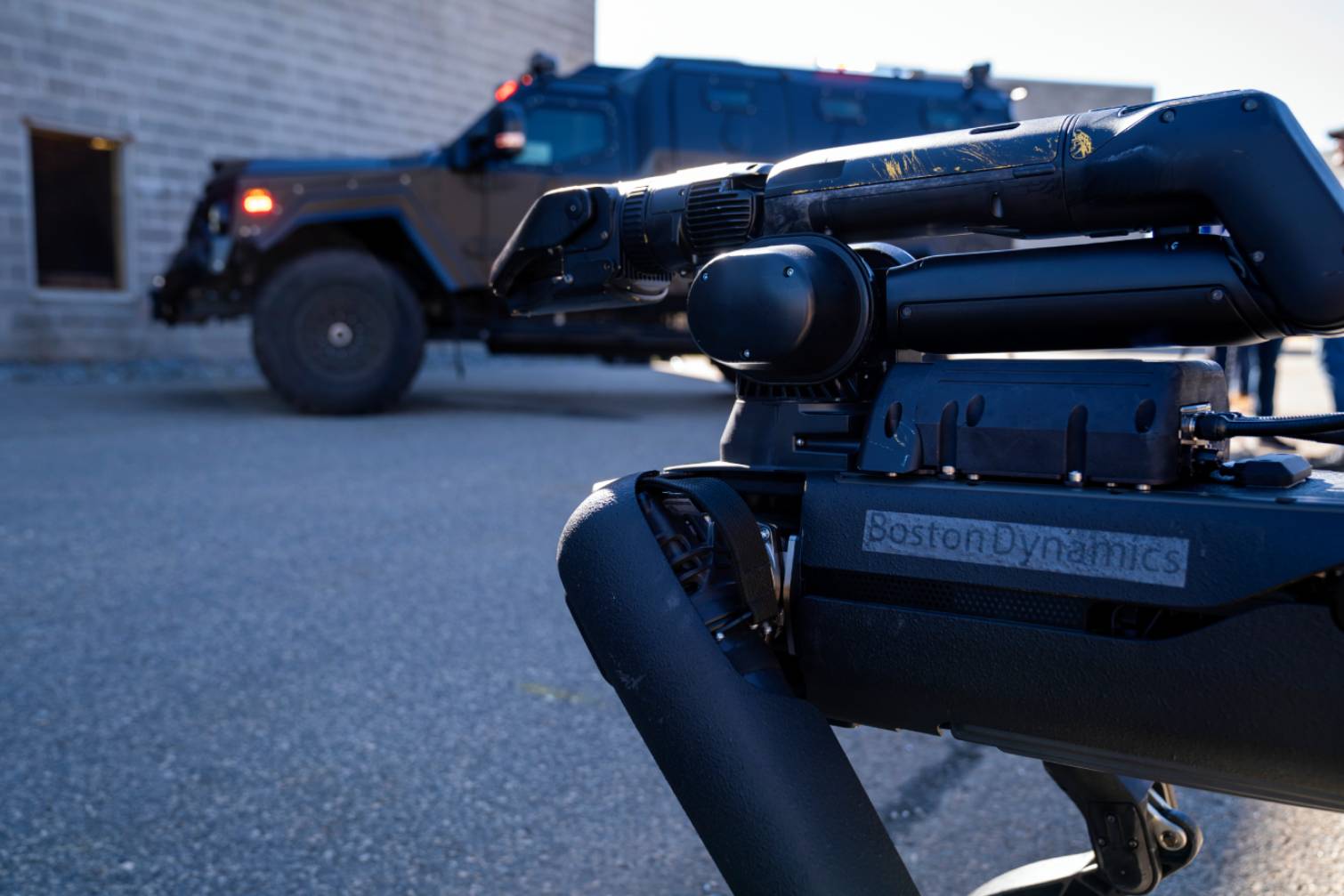 Boston Dynamics Spot robot outside of a building with a vehicle