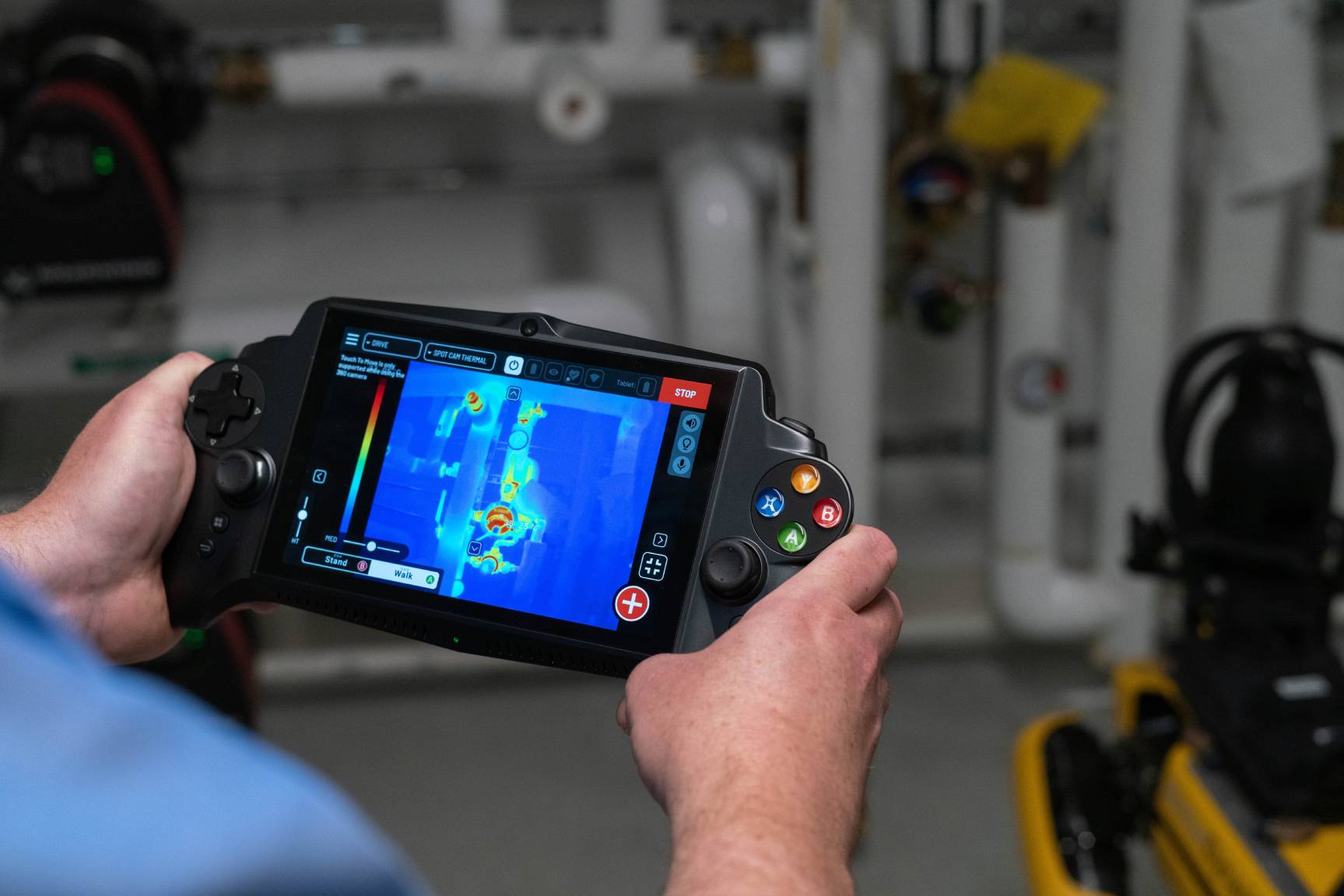 A worker reviews a thermal image captured by Spot on the tablet controller