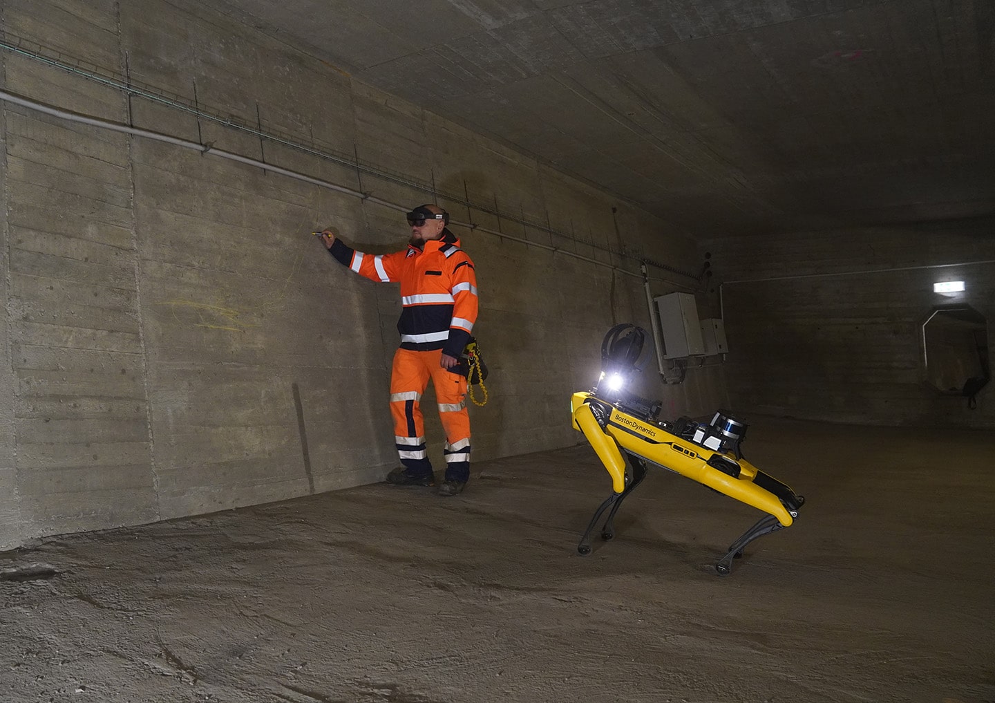 Boston Dynamics' agile mobile robot Spot inside Köhlbrand Bridge. Using AR glasses, the employee sees spots marked on the bridge’s digital twin. (image source: HPA / Florian Steffens)