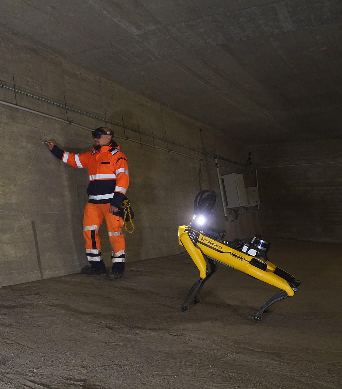 An inspector works inside a bridge using Spot to develop a digital twin