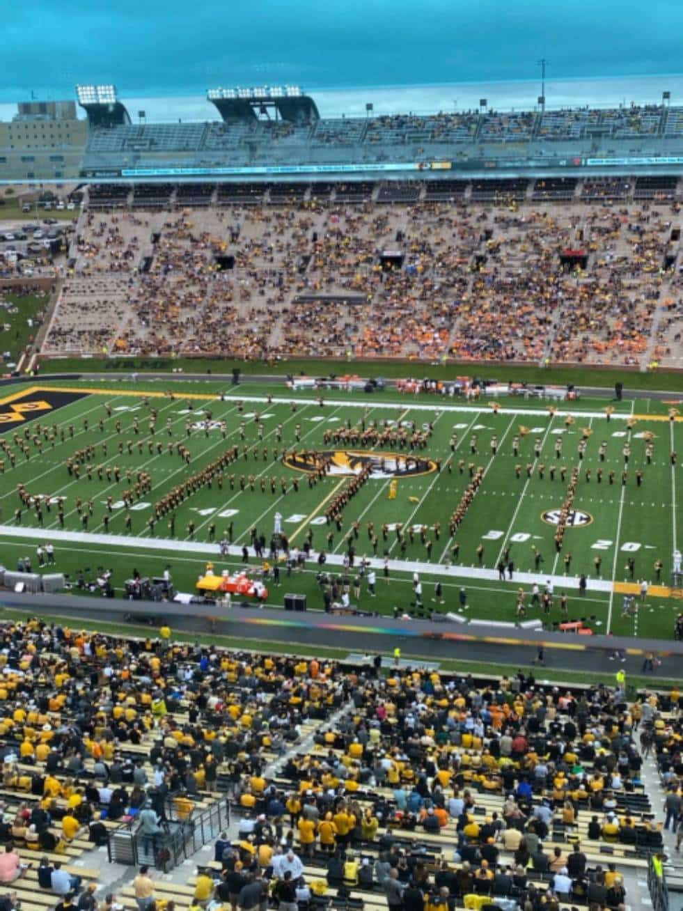 The University of Missouri College of Engineering Marching Band spelling "SPOT" with their bodies in the school's football stadium