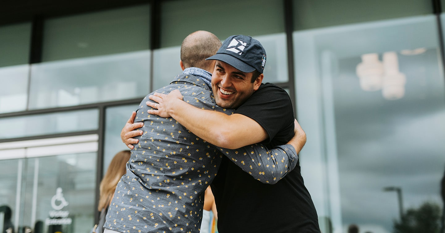 Two Boston Dynamics employees hug