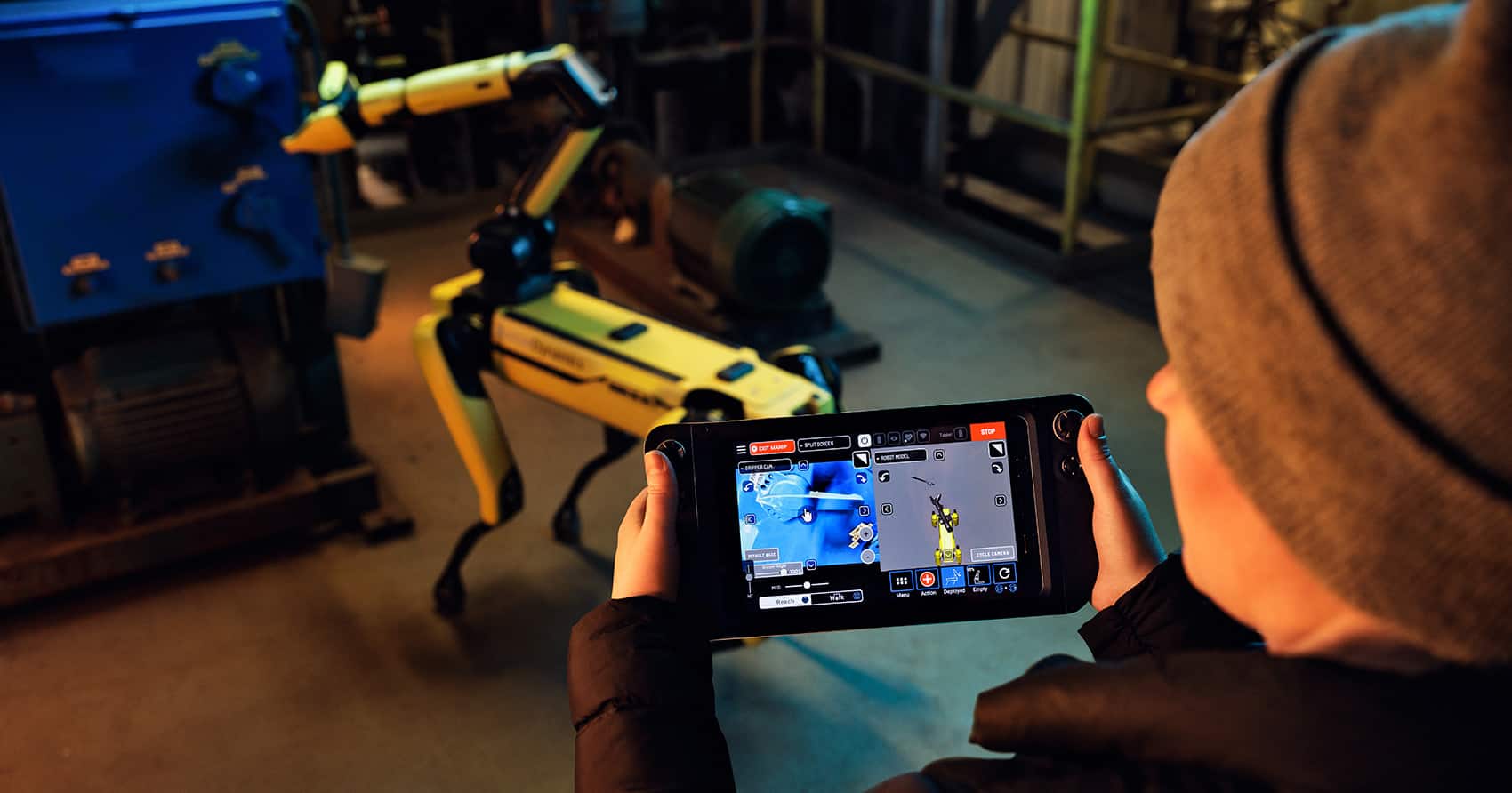 An operator uses the Spot tablet controller to direct Spot to flip a lever