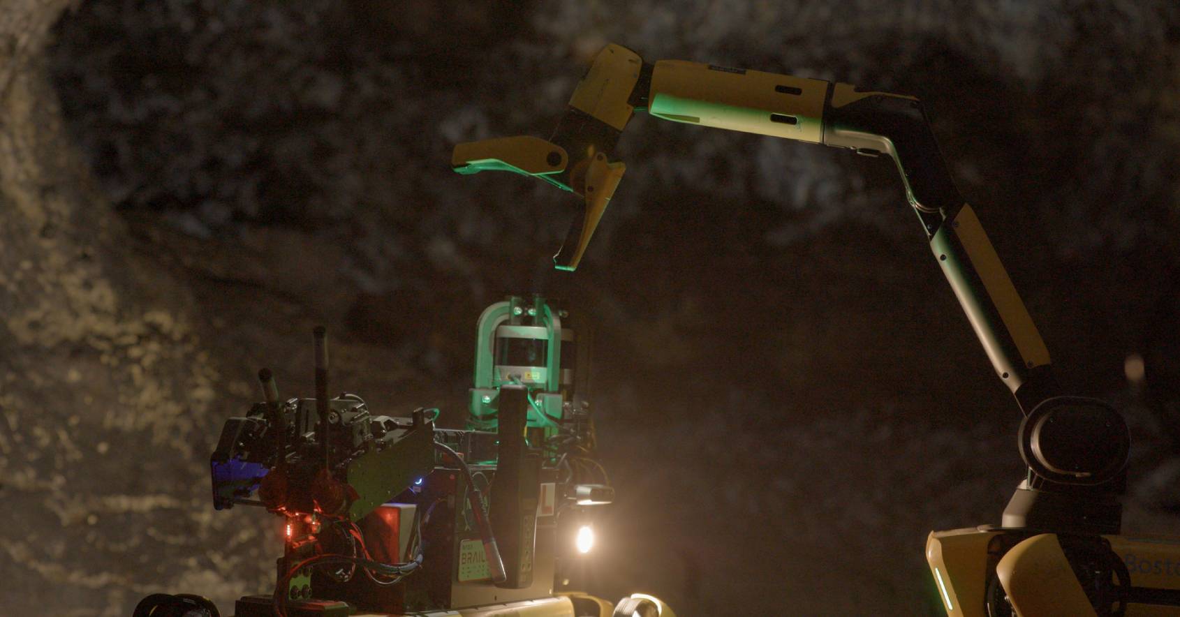 Spot Arm reaching for equipment in a cave