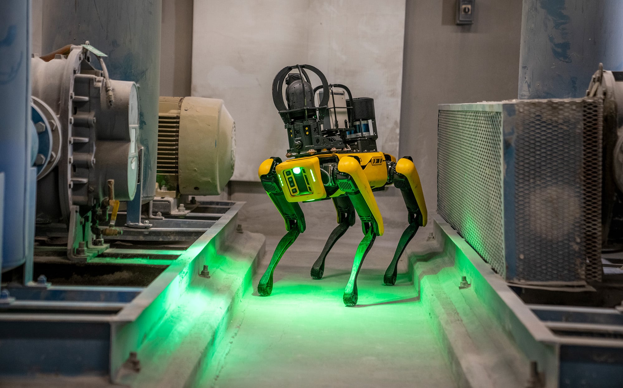 Spot robot equipped for visual, thermal, and acoustic inspection next to an industrial motor