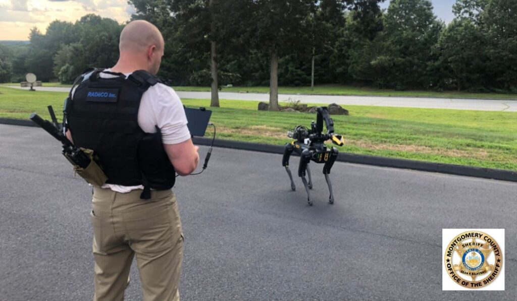 An operator in a tactical vest drives Spot