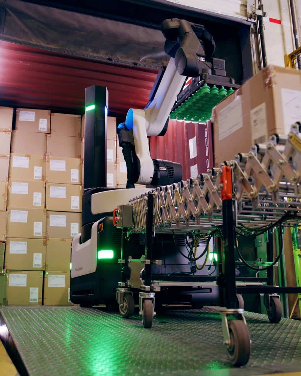 Stretch robot having placed a cardboard box from a conveyor belt captured from a low angle